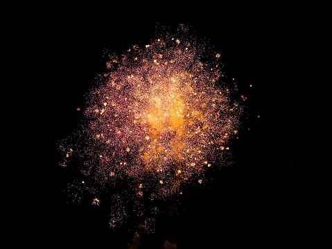 A colorful display of fireworks explodes in the night sky, with some bursts going beyond their designated area and out of control