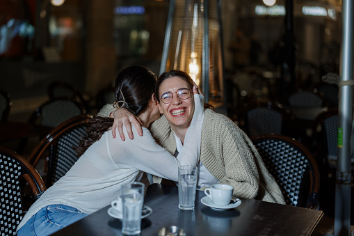 Two Female Friends Deep in Conversation, Expanding Perspectives at a Café