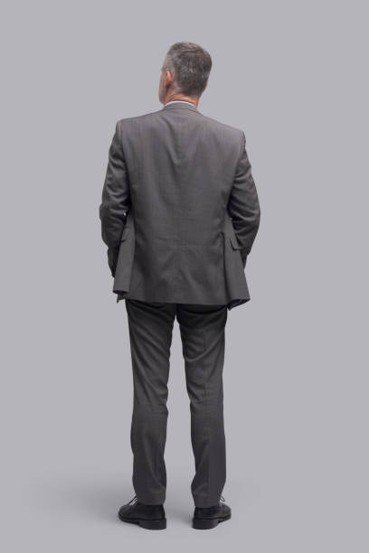 istock Corporate businessman standing back view 1569024424