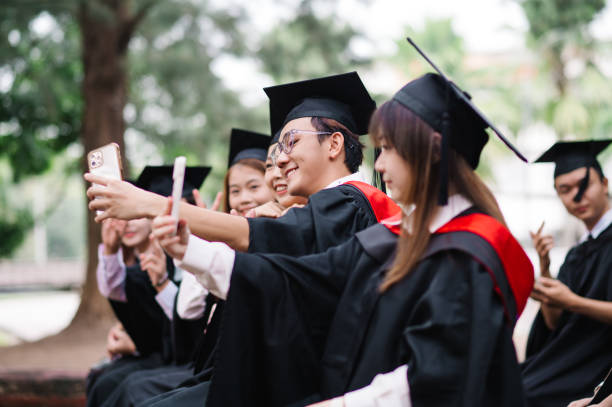 istock Graduates taking wefie together 1569027202