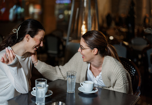 Two Female Friends Cherishing Moments of Conversation in a Café