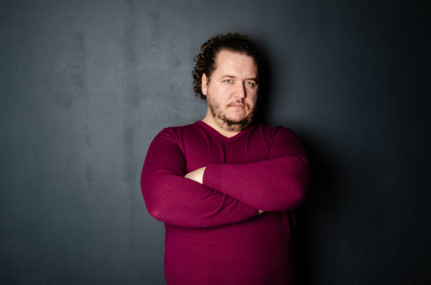 istock Business and work. Funny fat man posing in the studio. 1569038340