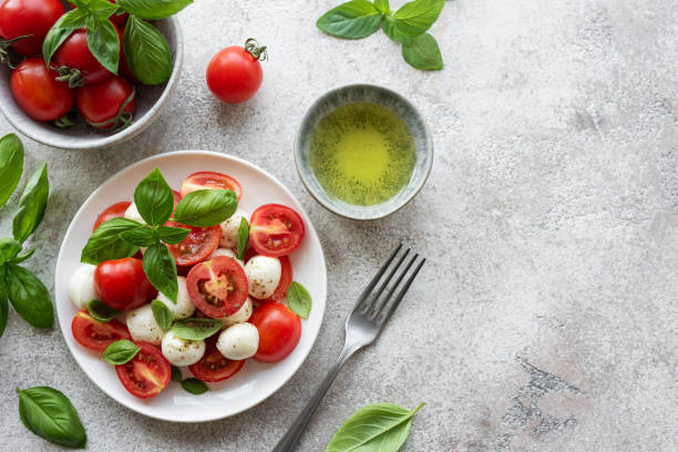 istock Caprese salad with tomatoes, mozzarella and basil. 1569054775