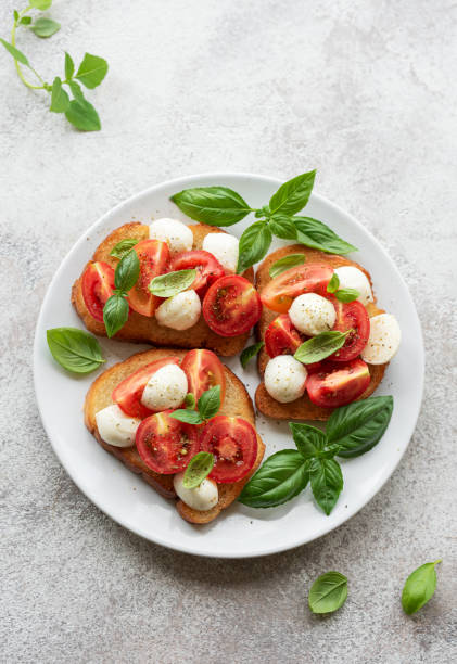 istock Caprese salad with tomatoes, mozzarella and basil. 1569054782
