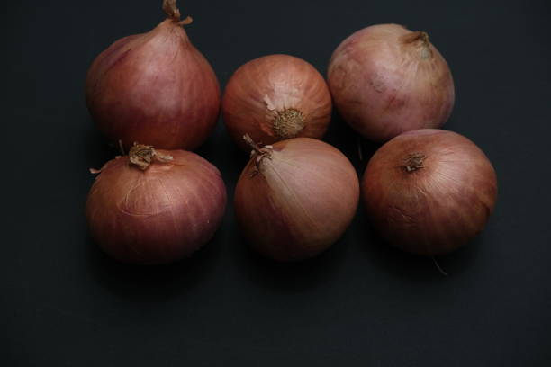 istock Onions  on the black background 1569078674