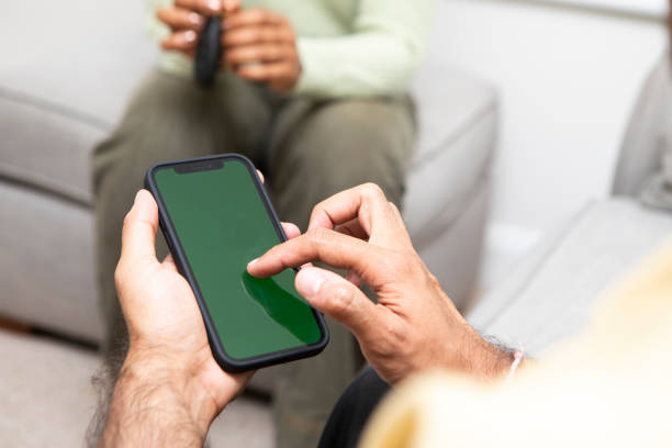 istock Close-up of hands using a mobile app at home 1569094393