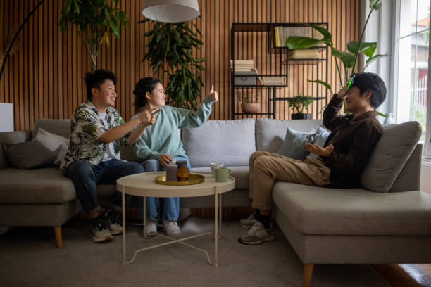 istock Young friends playing a guessing game with a smartphone at home 1569097442