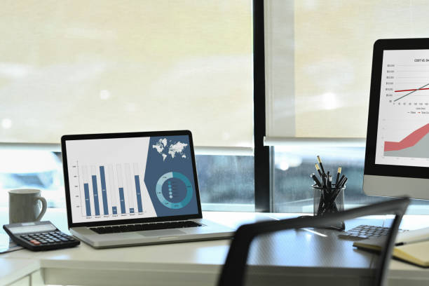 istock Laptop computer with statistics, marketing research results or statistics data on screen and calculator on white office desk. 1569097984