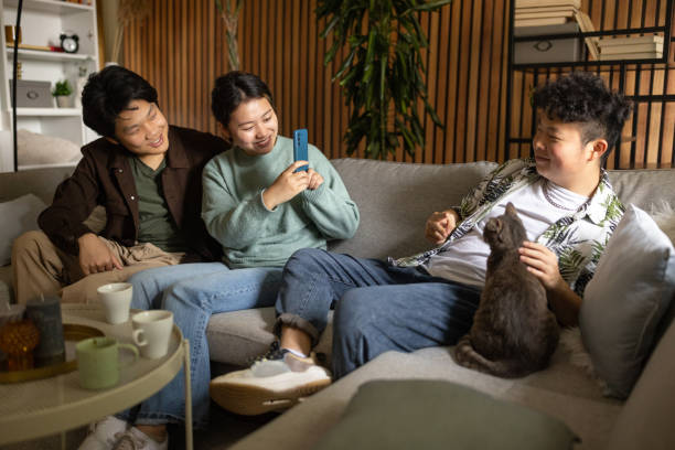 istock Young friends using a smartphone at home 1569111992