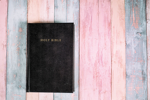 The Holy Bible on the wooden background. Christian background concept with copy space