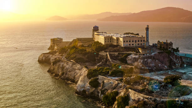 View of Alcatraz Island Aerial view of prison building on Alcatraz Island during sunset, San Francisco Bay, California, USA. alcatraz island photos stock pictures, royalty-free photos & images