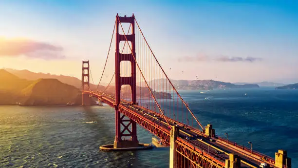 Aerial view of traffic moving on Golden Gate Bridge during sunset, San Francisco, California, USA.