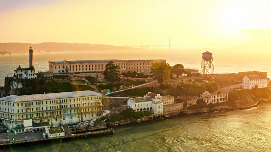 Aerial view of prison building on Alcatraz Island during sunset, San Francisco Bay, California, USA.