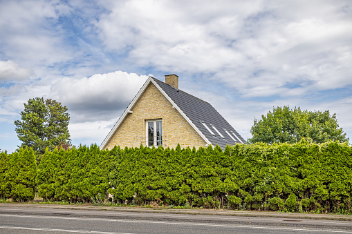 Værløse, Copenhagen, Denmark - July 19th 2023: Residential house behind a hedge, it is normal in Danish suburbs to have hedges round the house and garden to protect the privacy of the residents