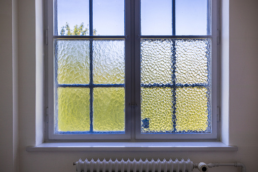 View out of a old window with two kinds of frosted glass