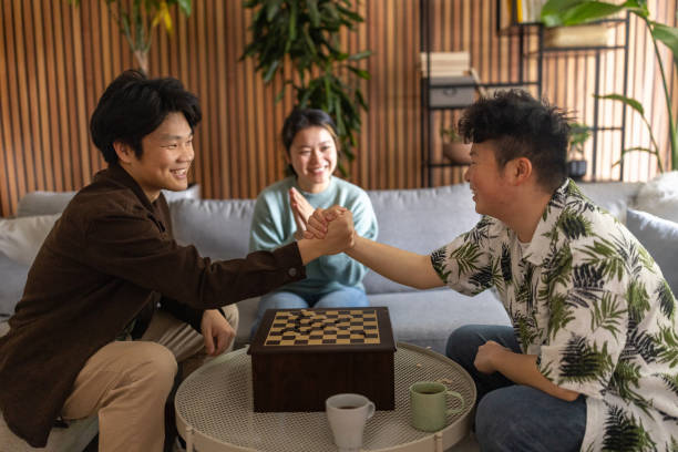 istock Two young men playing checkers at home 1569154916