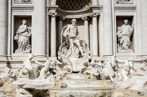 The famous Trevi fountain seen from the front. daylight photography with natural light, long exposure to highlight the movement of the water falls.