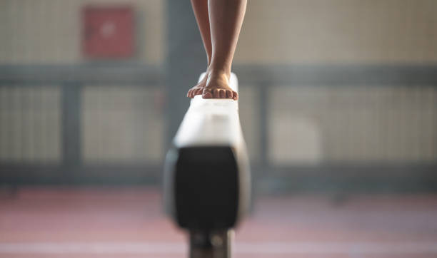 Feet Of Young Gymnast On Balance Beam stock photo