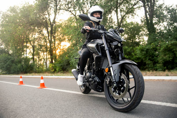 istock Young woman learning to ride a motorcycle 1569183438