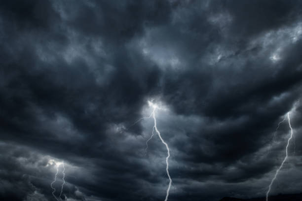 istock Thunderous dark sky with black clouds and flashing lightning. Panoramic view. Concept on the theme of weather, natural disasters, storms, typhoons, tornadoes, thunderstorms, lightning, lightning. 1569184310