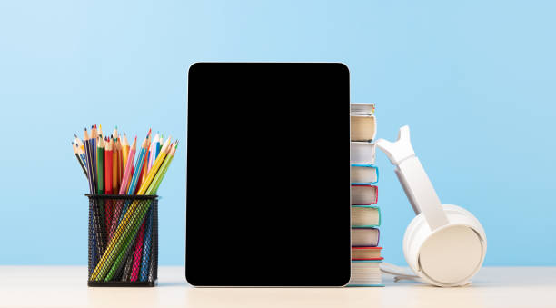 istock Tablet with colorful pencils and stack of books 1569185458