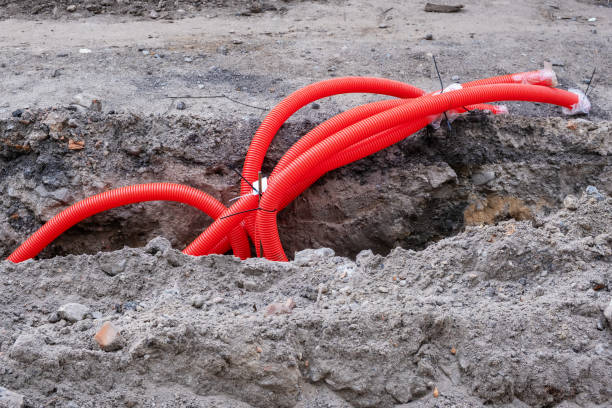 istock Red corrugated pipes in a trench 1569186580