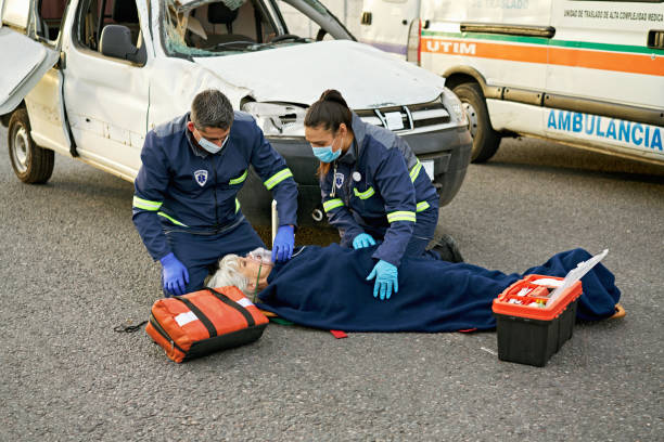 istock Two paramedics caring for female accident victim 1569188195