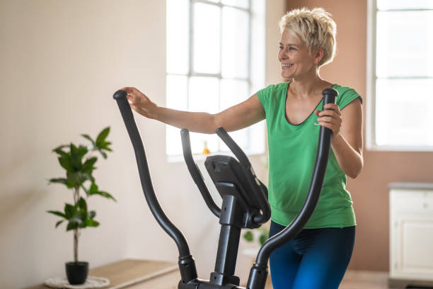 istock Woman training using elliptical cross trainer 1569196299