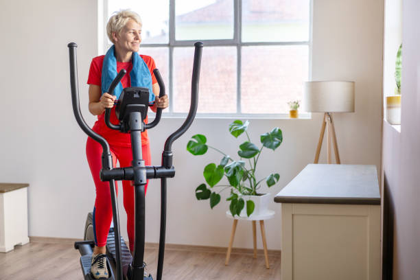 istock Woman Exercising on Elliptical Cross Trainer 1569196323