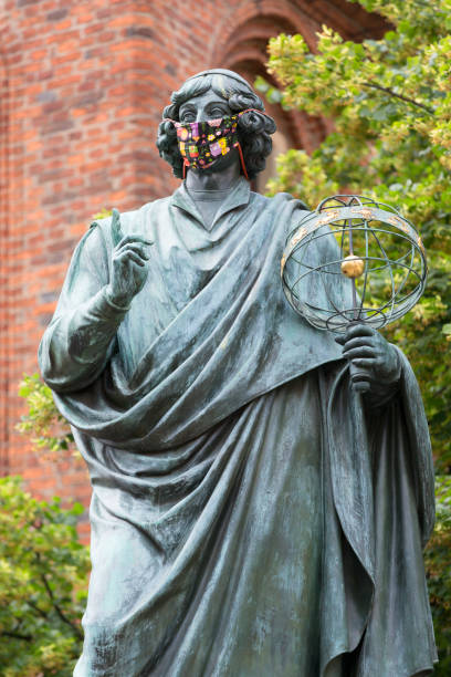 Nicolaus Copernicus Monument, statue of polish renaissance astronomer, Torun, Poland Torun, Poland - June 26, 2020: Nicolaus Copernicus Monument, statue of polish renaissance astronomer on the Old Town Square in front of the Town Hall. Sculpture with a protective mask, Covid-19 pandemic time madieval stock pictures, royalty-free photos & images