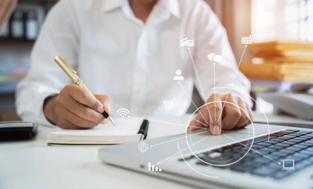 istock business man hand working with laptop computer, tablet and smart phone in office with digital marketing media  in virtual icon at  office in morning light . 1569228757