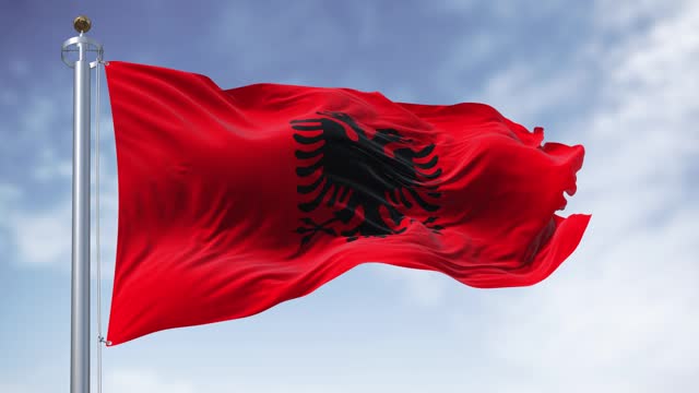 Albanian national flag waving in the wind on a clear day