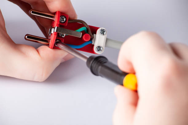 istock electrician disassembles electric plug. Electric plug with outlet isolated on white background. European electric plug assembly. dismantled electric plug. 1569228953