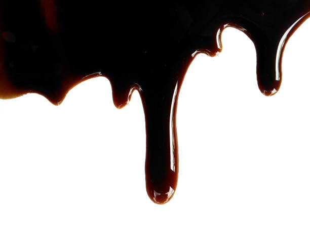 istock Soy sauce on white background. Spilled soy sauce sauce puddle isolated on white background. Texture of spilled soy sauce. 1569236109
