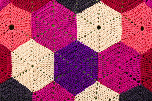 Handmade colorful crocheted background. Close-up of knitted pattern