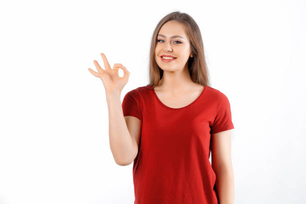 istock Okay, perfect. Smiling beautiful brunette girl, showing ok, zero gesture, no problem sign, recommending something, standing satisfied against white background 1569237677