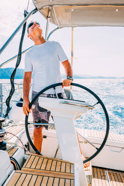istock Skipper sailing on sailboat 1569243724