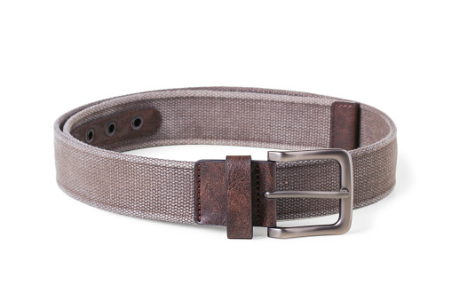 Men's waist belt made of coarse fabric with leather inserts, twisted into a ring, isolated on a white background