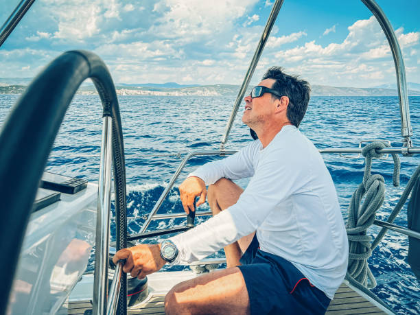 istock Skipper sailing on sailboat 1569247560