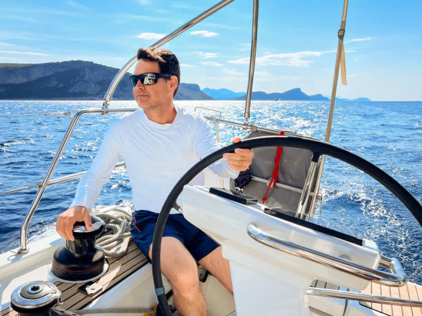 istock Skipper sailing on sailboat 1569249755