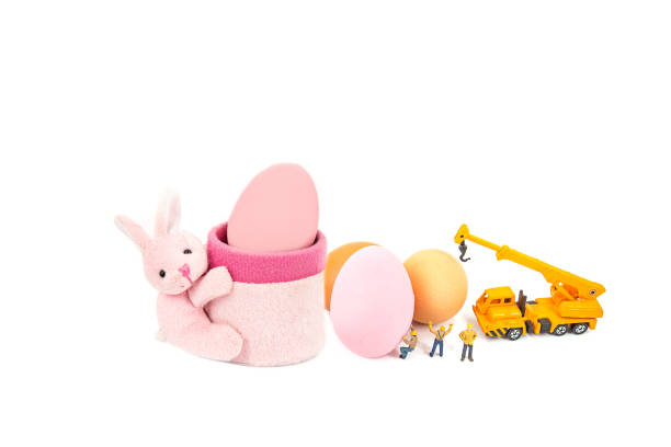 miniature worker people and egg , isolated on white background