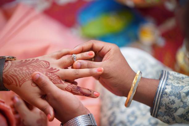 istock Hands of a couple just getting married 1569262264