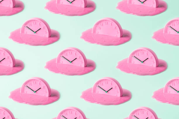 Creative concept of time. Pink clock pattern on turquoise background.