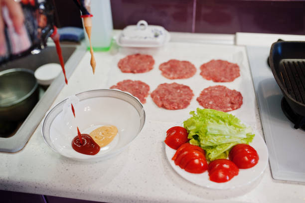 ooking burgers in the kitchen at home during quarantine time.