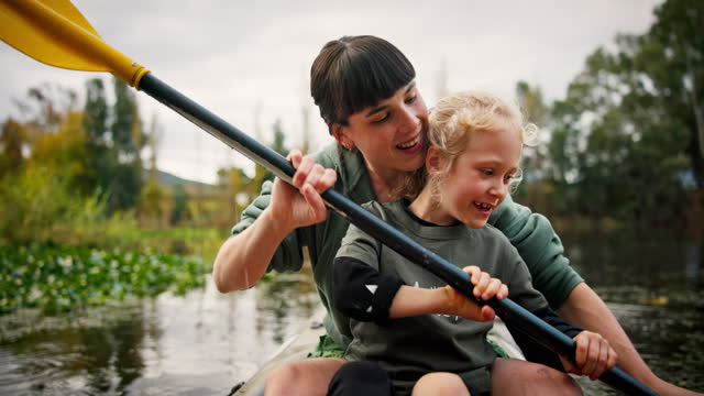 Mother, girl and rowing kayak in river on holiday, vacation or travel together. Mom, child and paddle in boat, canoeing and bonding at lake, water and learning to exercise on family adventure outdoor
