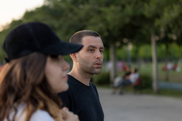 istock Young couple is walking around at public park. 1569297656