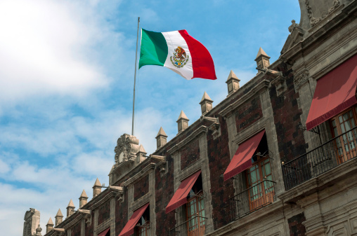 Mexico's old building with flag.