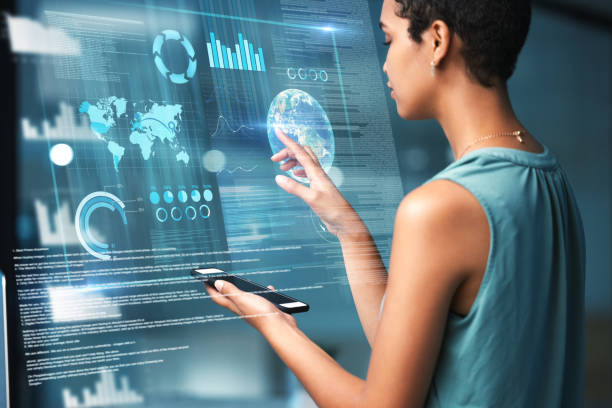 istock Virtual reality, phone and global overlay with a business black woman using an ai ux interface to access a metaverse of data. Digital, finance or information for a global network on a 3d hologram 1569330167