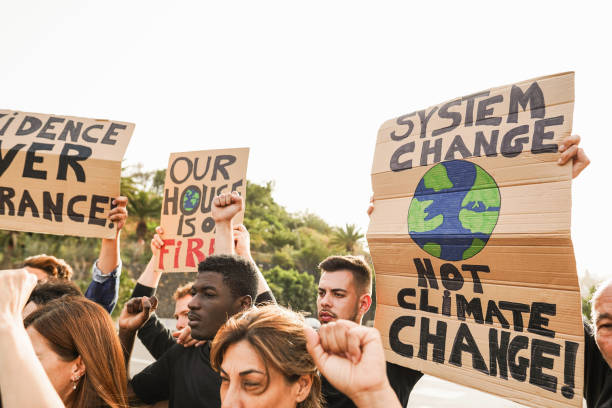 istock Multigenerational people protest against climate change - Crowd doing demonstration for stopping pollution and weather disasters - Environmental and save the planet concept - Focus on right cartel 1569334511