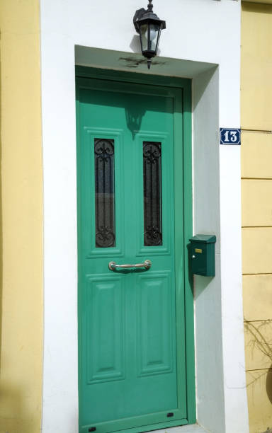 istock green front door with small metal decorative inserts and a lamp on top 1569359307